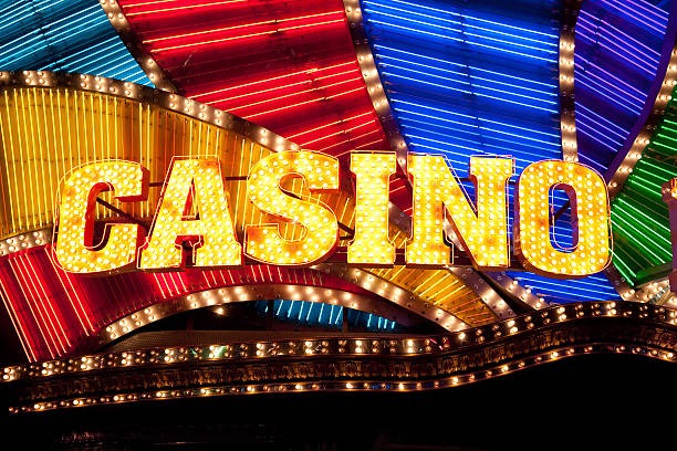 Live dealer dealing cards at a baccarat table